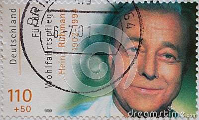 a postage stamp from Germany, showing a portrait of a portrait of the actor, director and singer Heinz RÃ¼hm Editorial Stock Photo