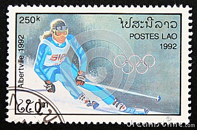 Postage stamp Laos 1992, Olympic Games Alpine Skiing contestant Editorial Stock Photo