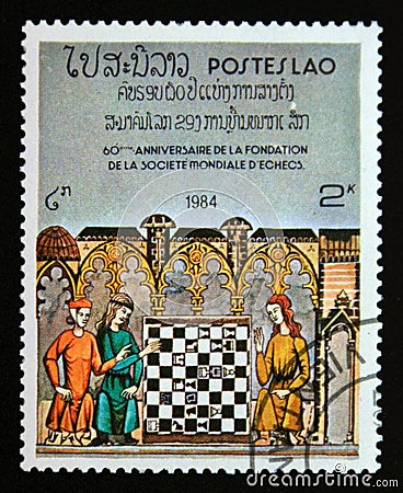 Postage stamp Laos 1984. Woman teaching girls to play chess Editorial Stock Photo