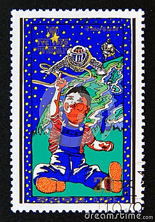 Postage stamp North Korea, 1979. Boy with model spaceman Editorial Stock Photo