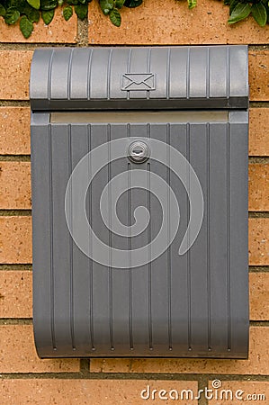 postbox on brick wall Stock Photo