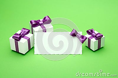 Postcard and gifts on green background Stock Photo