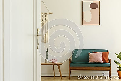 Poster above green couch with pillows in living room interior wi Stock Photo