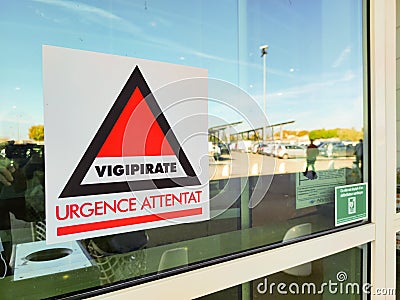 Poster at the entrance of a supermarket displaying Vigipirate, urgence bombat Editorial Stock Photo