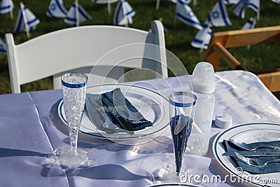 A Shabbat Table Setting with a Baby Bottle for the Infant who's name is on the poster at the back of the chair Stock Photo