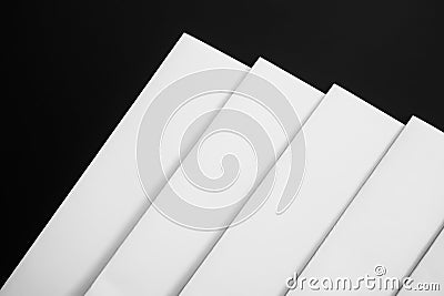 Poster mock-ups paper, white paper isolated on black background, Blank portrait paper A4. brochure magazine or blank newspapers Stock Photo