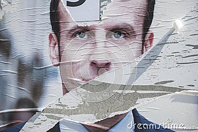 Poster Torn by an angry citizen of the president of `en marche` Editorial Stock Photo