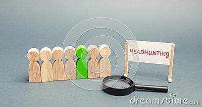 A poster with the word Headhunting, a crowd of people and a magnifying glass. The concept of hiring people to work. Staff Stock Photo