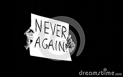 Poster with the words Never Again in the hands Stock Photo