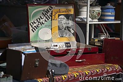 Posters on the table and other things on the Spitalfields market near Liverpool Street subway. Editorial Stock Photo