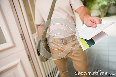 Postman delivering a letter Stock Photo