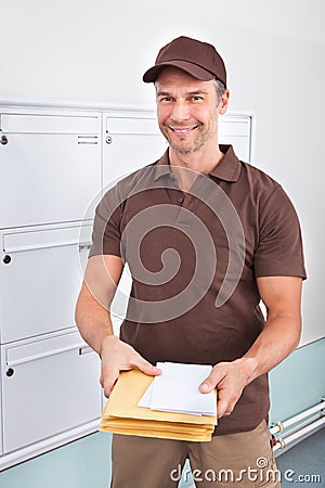 Postman holding letters Stock Photo