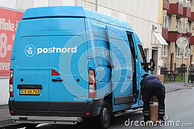 POSTNORD DELIVERY MAN WITH PACKETS Editorial Stock Photo