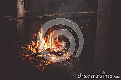 A pot of boiling water on the fire in the forest. Stock Photo