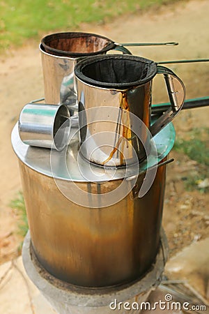 Pot of hot water boiler on wood fueled stove with coffee filter Stock Photo