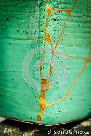 Pot repaired by kintsugi with gold Stock Photo