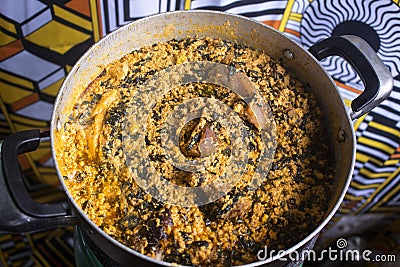 A pot of tasty Egusi soup cooked with assorted meat and fish Stock Photo