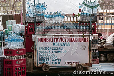 A potable mobile outdoor market vendor food stall display with soda water, soft drinks and water bottles in a roadside eatery in Editorial Stock Photo