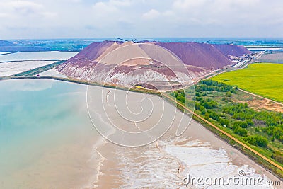 Potassium waste piles near reservoir aerial landscape. Environmental problems Stock Photo