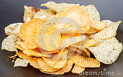 Potato chip on black dish Stock Photo