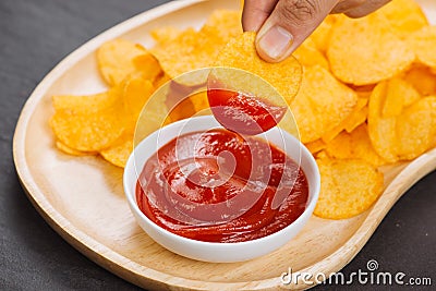 Potato chips and ketchup. Beer snack, unhealthy eating Stock Photo