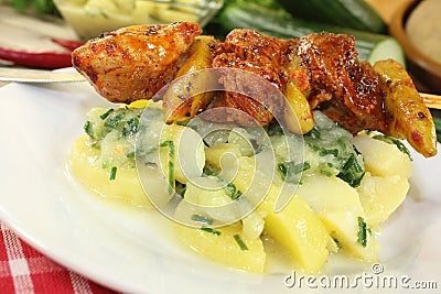 Potato-cucumber salad with fiery fire skewers Stock Photo