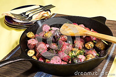 Potato medley meal cooked in a cast iron pan Stock Photo