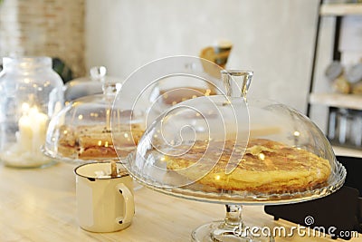 A potato omelette at the bar of a restaurant under a glass dome to offer as a tapa with the drink Stock Photo