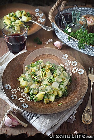 Potato salad with pickled cucumbers, parsley and olive oil, rustic style Stock Photo