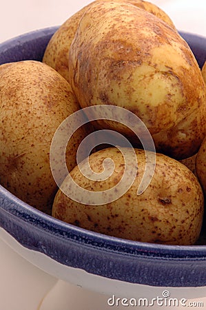 Potatoes in bowl Stock Photo