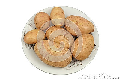 Potatoes in a ceramic dish isolated on white background. Harvesting and organic gardening. Country life. Top view. Stock Photo