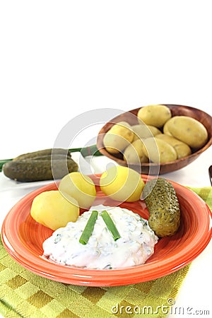 Potatoes with curd, pickles and chives Stock Photo