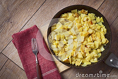 Potatoes fried in a pan, rustic style, Stock Photo