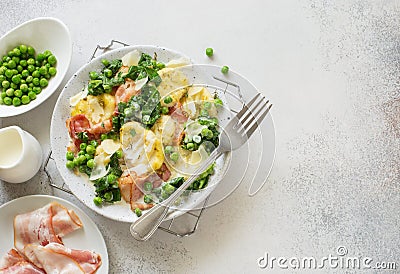Potatoes gnocchi, green peas, spinach and bacon Stock Photo