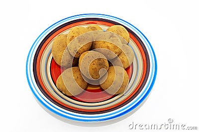 Potatoes on multicoloured plate Stock Photo