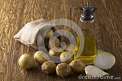 Potatoes, onion and bottle of vegetable sunflower oil Stock Photo