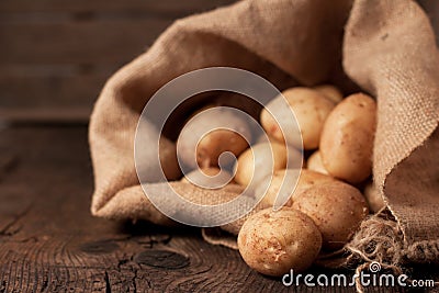 Potatoes in sack Stock Photo