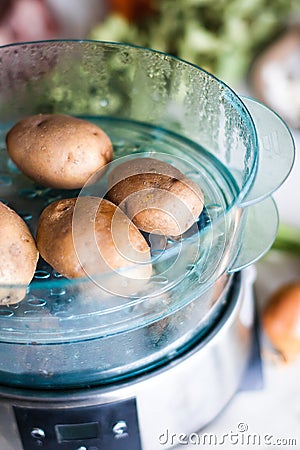 Potatoes in steamer Stock Photo