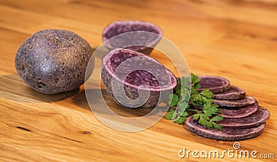 Potatoes variety `Bleue d`Artois` cut in slices Stock Photo