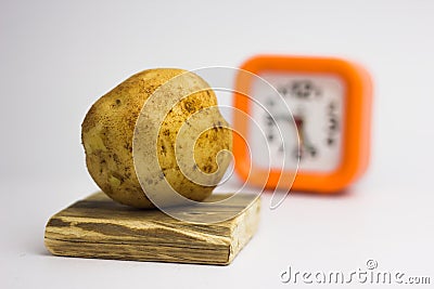 Potatoes on a white background regain the clock Stock Photo