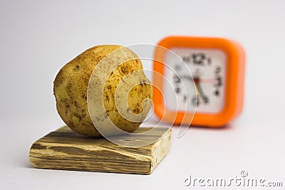 Potatoes on a white background regain the clock Stock Photo