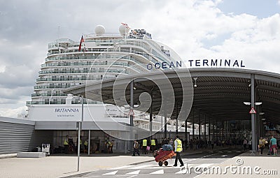 Poter with trolley and cruise ship Editorial Stock Photo