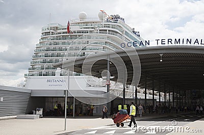 Poter with trolley and cruise ship Editorial Stock Photo