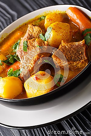 Potjiekos South African lamb stew with vegetables close-up on the table. vertical Stock Photo