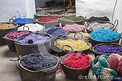 Pots with colorful yarns dyed in the old workshop Stock Photo