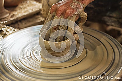 Potter makes on the pottery wheel Stock Photo