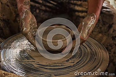 Potter makes on the pottery wheel Stock Photo