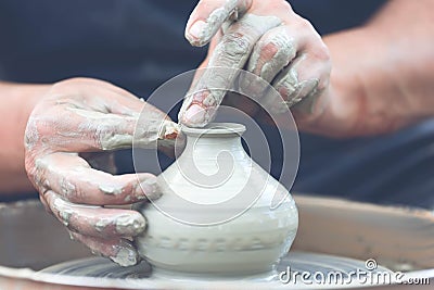 Potter making ceramic pot on the pottery wheel Stock Photo