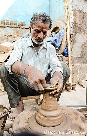A Potter making clay pots Editorial Stock Photo