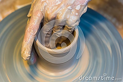 Pottering - creating a clay cup in process Stock Photo